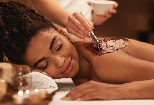 Therapist giving hot stone massage at IRA Spa in Mangalore